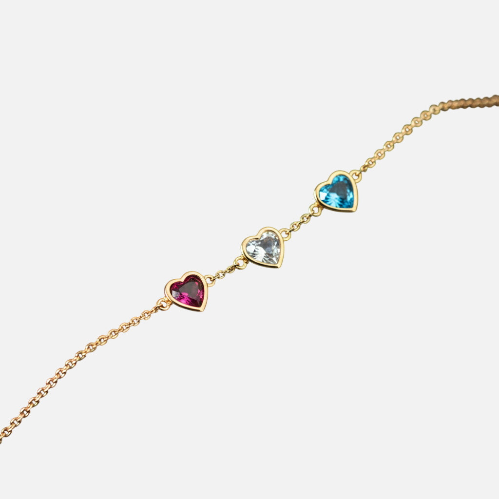 Gold heart bracelet on black velvet